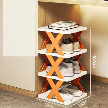 Orange and white shoe rack with shoes on a wooden floor.